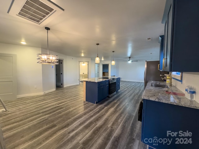 kitchen featuring dark wood-type flooring, stainless steel appliances, sink, pendant lighting, and ceiling fan