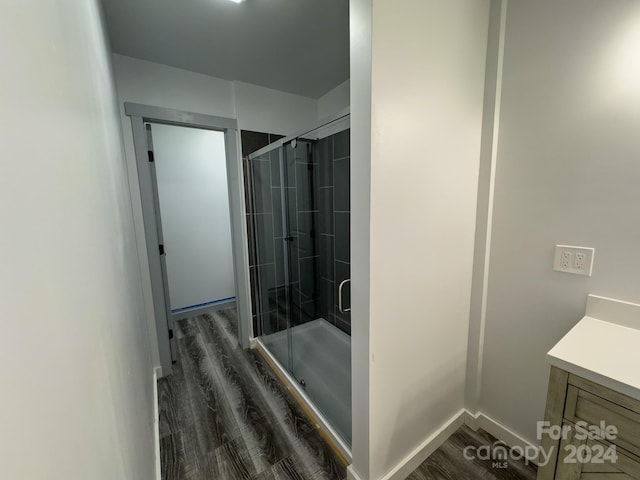 bathroom with vanity, hardwood / wood-style floors, and walk in shower