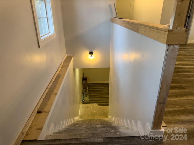 stairway with hardwood / wood-style floors