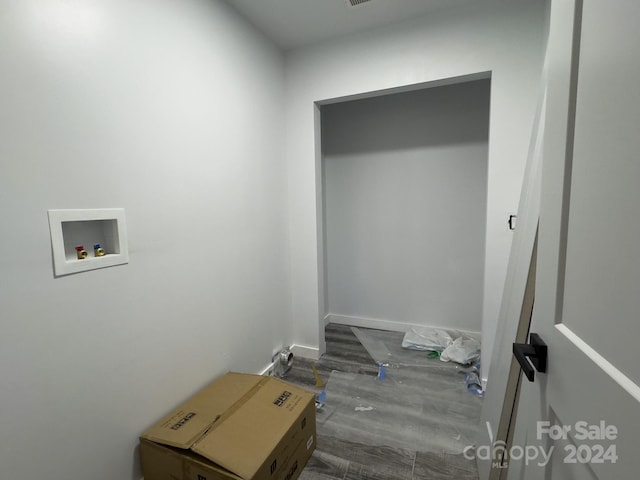 laundry room with dark hardwood / wood-style floors and washer hookup