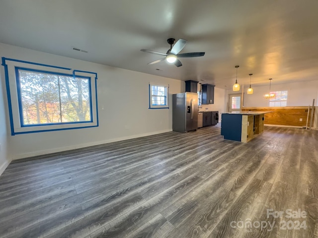 unfurnished living room with dark wood-type flooring and ceiling fan