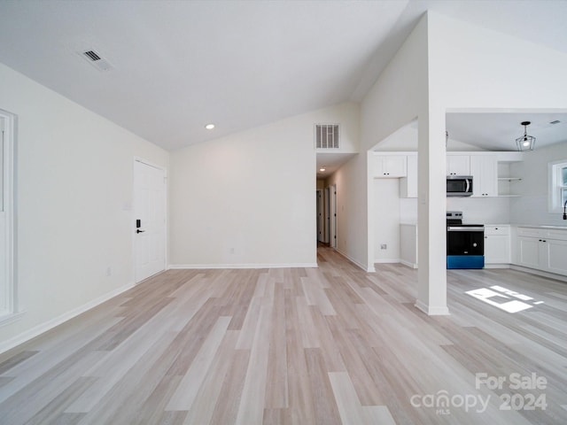 unfurnished living room with vaulted ceiling and light hardwood / wood-style flooring