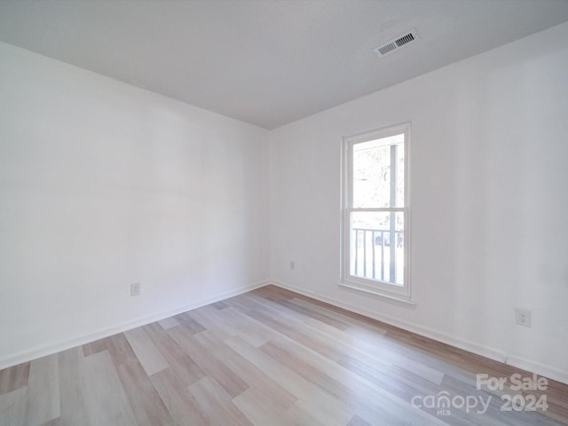 unfurnished room with light hardwood / wood-style floors