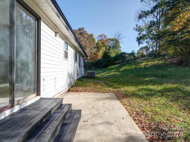 view of yard featuring a patio and central air condition unit