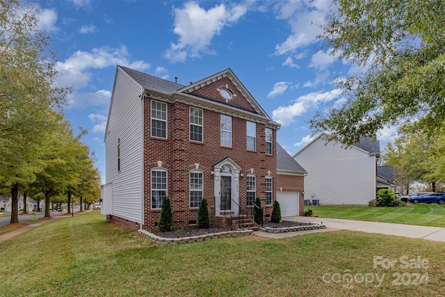 view of front of property featuring a garage and a front lawn