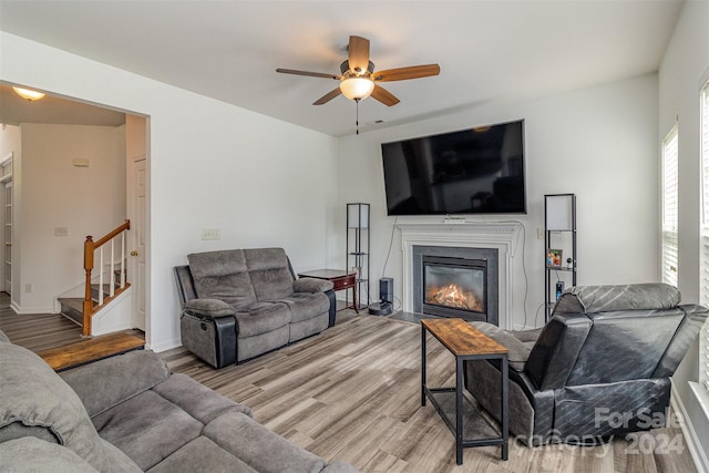 living room featuring ceiling fan and light wood-type flooring