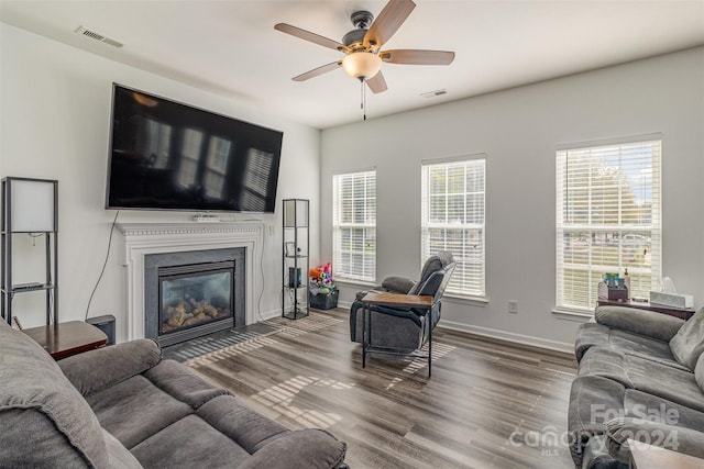 living room featuring hardwood / wood-style floors and ceiling fan