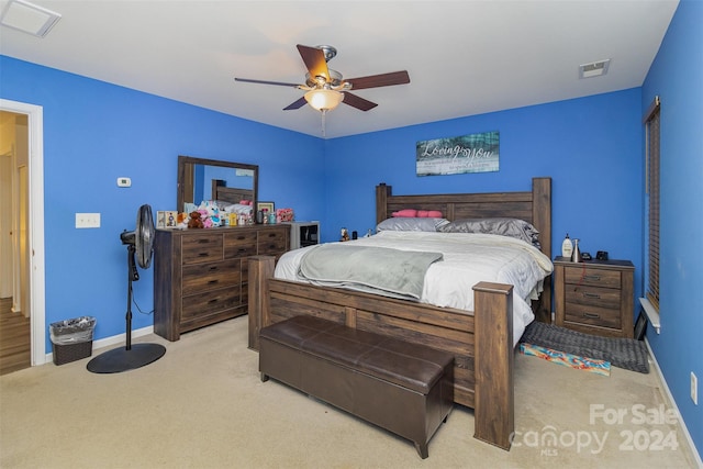 bedroom featuring light carpet and ceiling fan