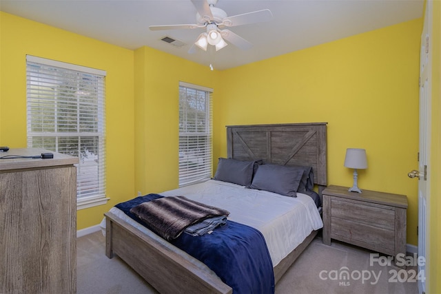 bedroom with light colored carpet and ceiling fan