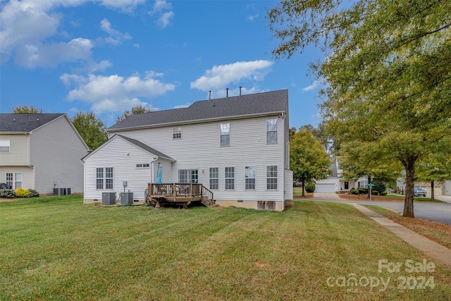 rear view of house featuring central air condition unit, a lawn, and a wooden deck