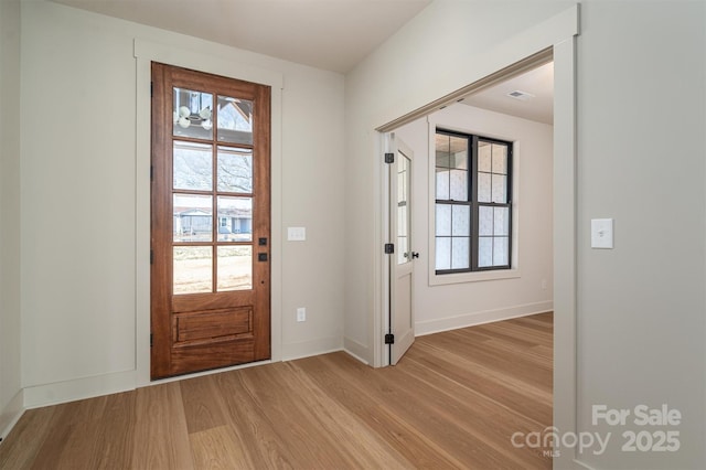 entrance foyer with baseboards and light wood finished floors