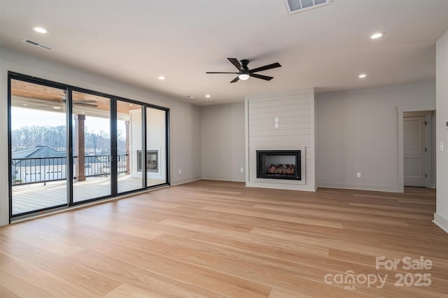 unfurnished living room featuring a fireplace, recessed lighting, visible vents, light wood-type flooring, and baseboards