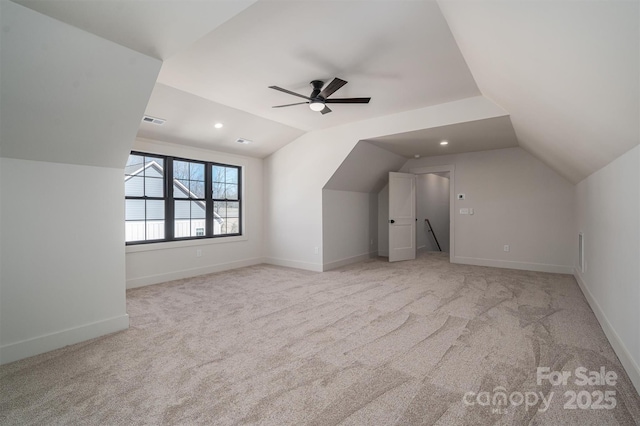 bonus room featuring light colored carpet, lofted ceiling, visible vents, and baseboards