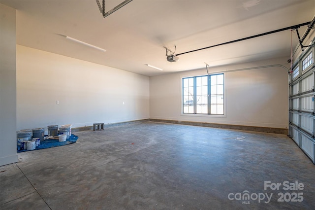 garage with a garage door opener and baseboards