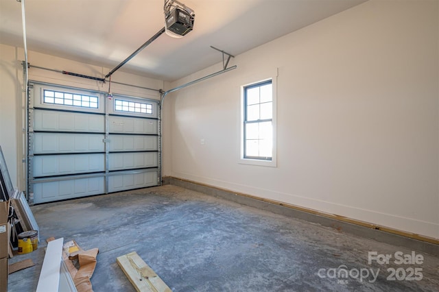 garage with baseboards and a garage door opener