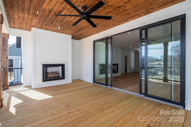 wooden terrace featuring ceiling fan