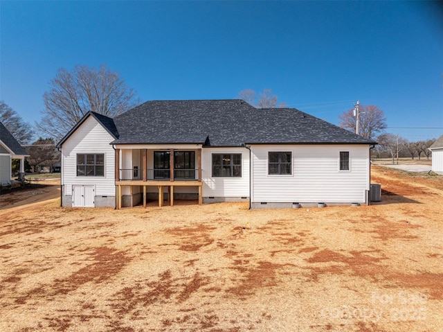 rear view of house with roof with shingles, crawl space, and cooling unit