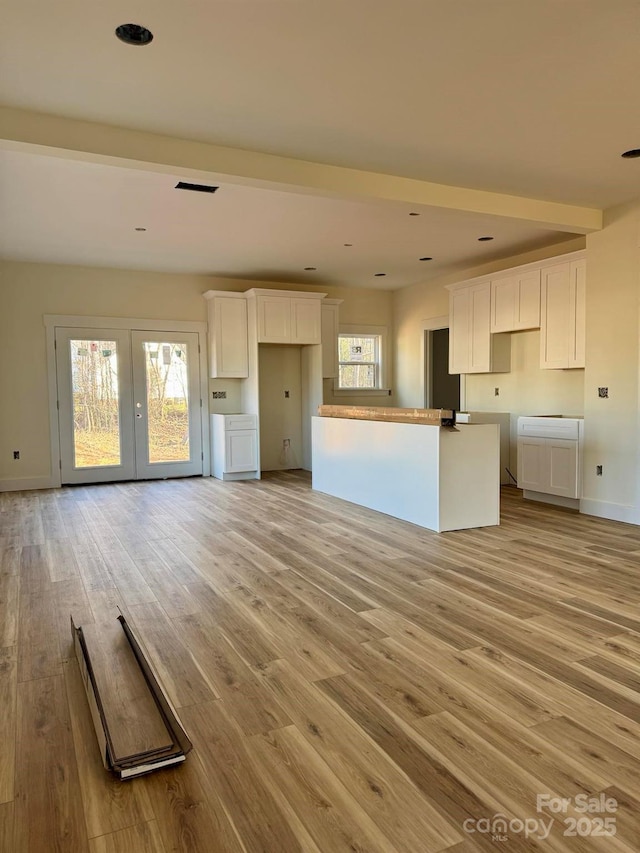 kitchen featuring plenty of natural light, light hardwood / wood-style flooring, and white cabinets