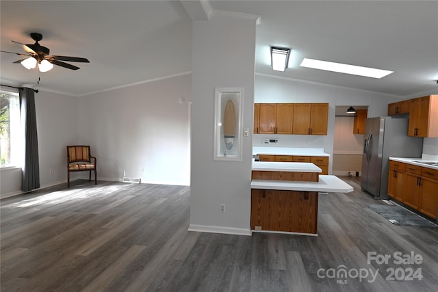 kitchen with lofted ceiling with skylight, ornamental molding, stainless steel fridge with ice dispenser, and dark hardwood / wood-style floors