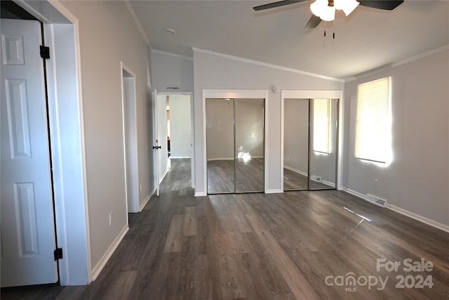 unfurnished bedroom featuring crown molding, dark wood-type flooring, vaulted ceiling, and ceiling fan