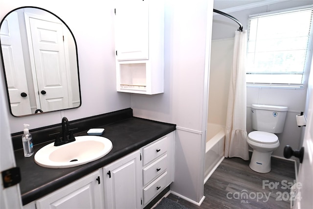 full bathroom featuring hardwood / wood-style floors, shower / bath combination with curtain, toilet, ornamental molding, and vanity