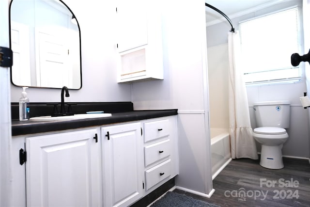 full bathroom featuring hardwood / wood-style flooring, toilet, ornamental molding, vanity, and shower / tub combo with curtain