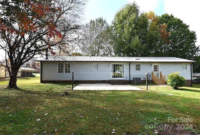 rear view of property with a yard, a patio area, and central AC unit