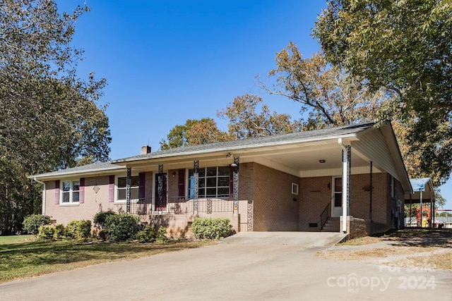 single story home with covered porch and a carport