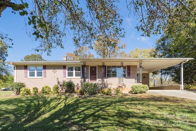 single story home with covered porch, a front lawn, and a carport