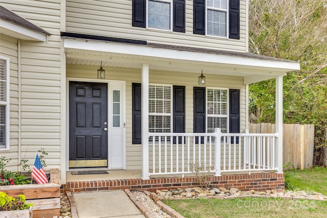 view of exterior entry with a porch