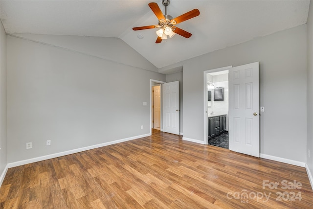 unfurnished bedroom with ensuite bathroom, light hardwood / wood-style floors, lofted ceiling, and ceiling fan