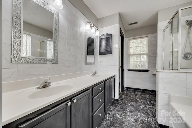 bathroom featuring tile walls, vanity, and walk in shower