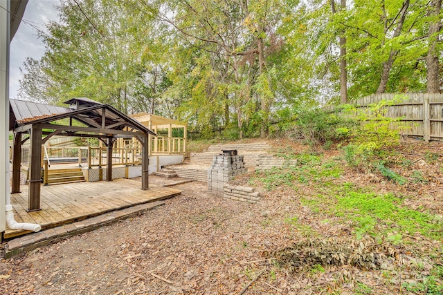 view of yard with a wooden deck and a gazebo