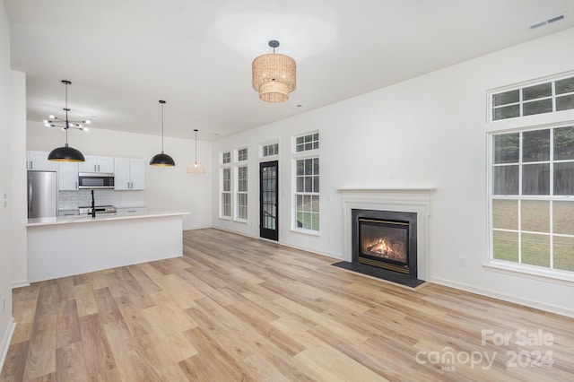 unfurnished living room featuring light hardwood / wood-style flooring