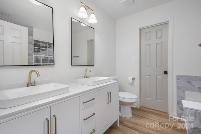 bathroom featuring vanity, hardwood / wood-style flooring, and toilet