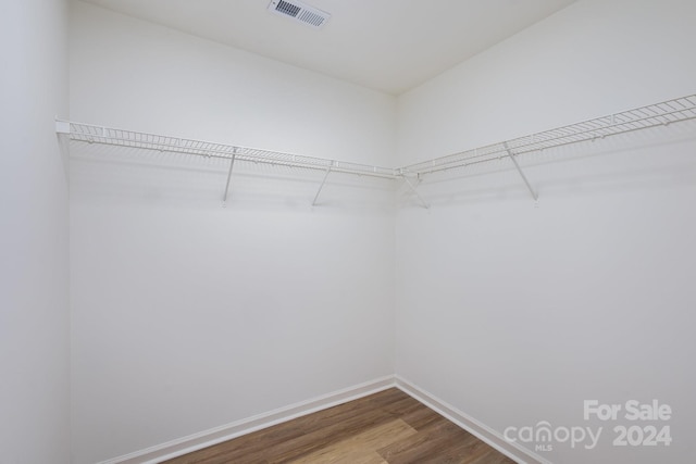 spacious closet with hardwood / wood-style floors