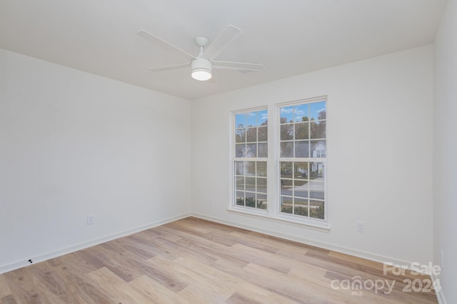 spare room with light hardwood / wood-style flooring and ceiling fan