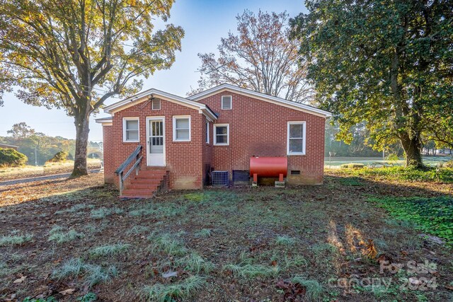 24947 Nc-24/27 Hwy, Albemarle, NC 28001 - rear view of house featuring entry steps, brick siding, and crawl space
