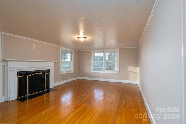 24947 Nc-24/27 Hwy, Albemarle, NC 28001 - unfurnished living room with ornamental molding, a tile fireplace, and light wood-type flooring