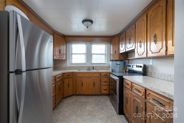 24947 Nc-24/27 Hwy, Albemarle, NC 28001 - kitchen with appliances with stainless steel finishes, brown cabinets, and light countertops