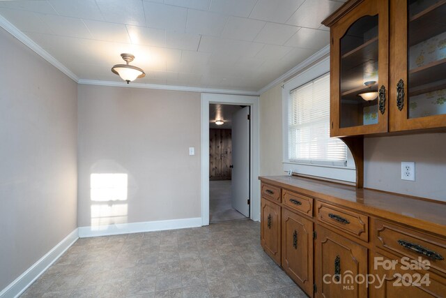 24947 Nc-24/27 Hwy, Albemarle, NC 28001 - kitchen with crown molding, brown cabinetry, and glass insert cabinets