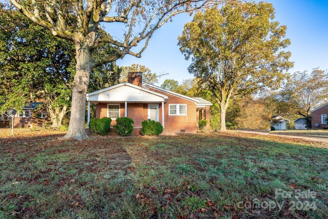 24947 Nc-24/27 Hwy, Albemarle, NC 28001 - view of front of home with brick siding, a chimney, and crawl space