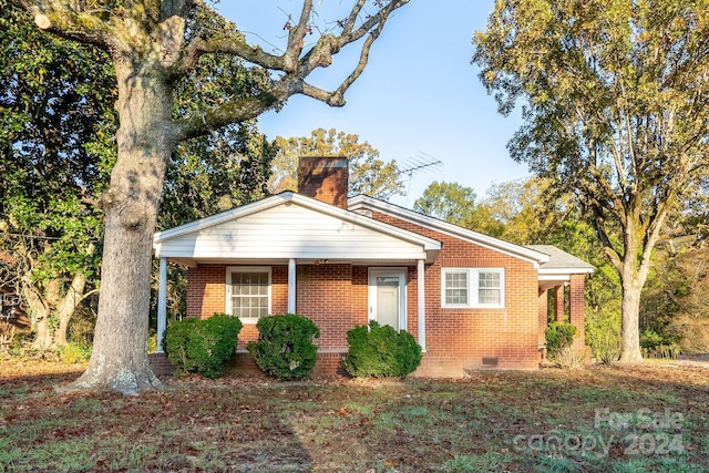 24947 Nc-24/27 Hwy, Albemarle, NC 28001 - view of front facade featuring crawl space, brick siding, and a chimney