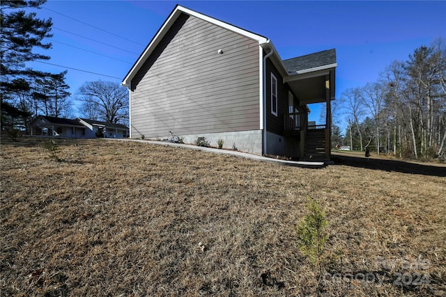 view of property exterior with a lawn