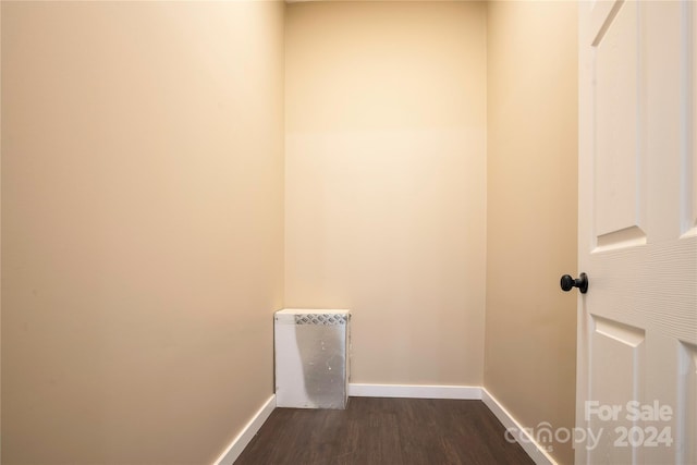 clothes washing area featuring dark hardwood / wood-style floors