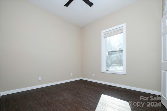 unfurnished room featuring ceiling fan and dark wood-type flooring