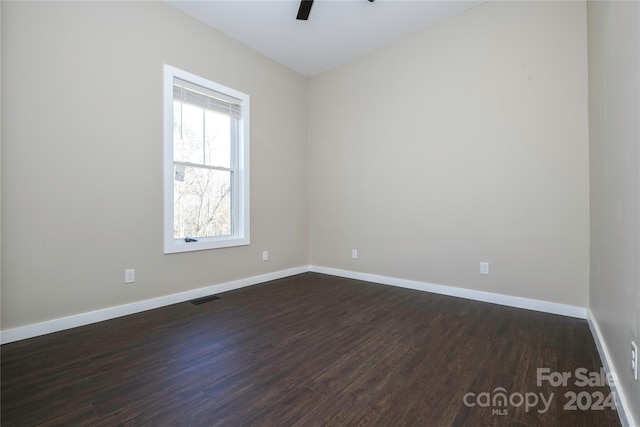 empty room featuring dark hardwood / wood-style flooring and ceiling fan