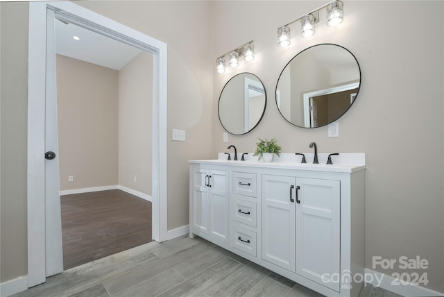 bathroom featuring hardwood / wood-style flooring and vanity