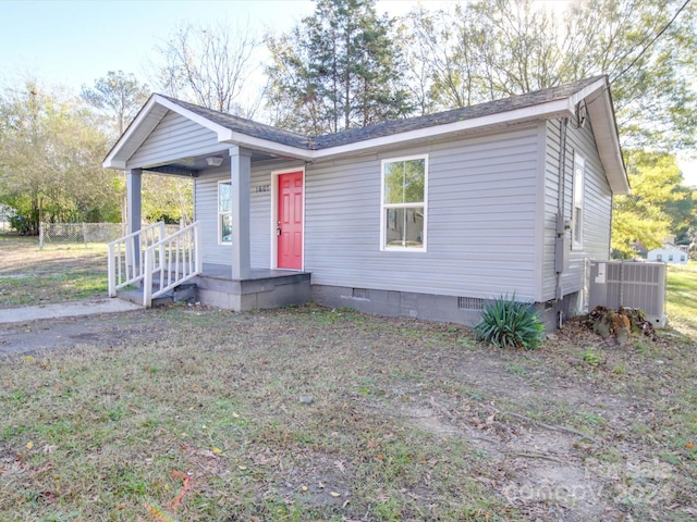 view of front of home with a porch and central air condition unit