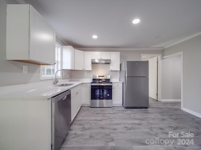 kitchen featuring white cabinetry, sink, light wood-type flooring, appliances with stainless steel finishes, and ornamental molding